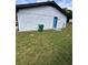 A backyard featuring a detached garage with a blue door and lush green grass at 4074 Green Hawk Trl, Decatur, GA 30035