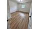 Cozy bedroom featuring hardwood floors and a modern light fixture at 4074 Green Hawk Trl, Decatur, GA 30035