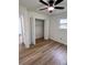Comfortable bedroom featuring hardwood floors, a modern ceiling fan, and a closet for ample storage at 4074 Green Hawk Trl, Decatur, GA 30035