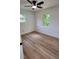 Bright bedroom featuring hardwood floors, a modern ceiling fan, and two windows that let in plenty of natural light at 4074 Green Hawk Trl, Decatur, GA 30035