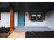 Stylish front porch with a vibrant blue door, dark accents, and tasteful landscaping at 4074 Green Hawk Trl, Decatur, GA 30035