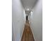 Long hallway with wood-look flooring leading to other rooms at 4074 Green Hawk Trl, Decatur, GA 30035