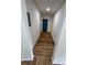 Bright hallway with sleek hardwood floors and a vibrant blue door adding a touch of color and style at 4074 Green Hawk Trl, Decatur, GA 30035