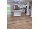 Open concept kitchen featuring stainless appliances, granite countertops, white cabinets, and hardwood floors at 4074 Green Hawk Trl, Decatur, GA 30035