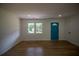 Bright living room with hardwood floors, a large window, and a vibrant blue door that adds a pop of color at 4074 Green Hawk Trl, Decatur, GA 30035