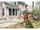 Backyard view of a home showcasing a concrete patio and a small, elevated wooden deck at 4344 White Surrey Nw Dr, Kennesaw, GA 30144