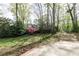 Spacious backyard with lush greenery, mature trees, and a view of the house at 4344 White Surrey Nw Dr, Kennesaw, GA 30144