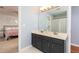 Bright bathroom with double vanity, modern fixtures and a view into the primary bedroom at 4344 White Surrey Nw Dr, Kennesaw, GA 30144