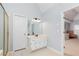 Bright bathroom featuring double sinks and vanity, with a view into the main bedroom at 4344 White Surrey Nw Dr, Kennesaw, GA 30144