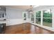 Dining area with hardwood floors, large windows providing outdoor views, and a glass door at 4344 White Surrey Nw Dr, Kennesaw, GA 30144