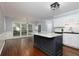 Open kitchen with island, stainless appliances, subway tile backsplash and large windows offering outdoor views at 4344 White Surrey Nw Dr, Kennesaw, GA 30144