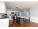 Well-lit kitchen featuring white cabinets, stainless steel appliances, and a dark central island at 4344 White Surrey Nw Dr, Kennesaw, GA 30144