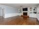 Spacious living room features hardwood flooring, a brick fireplace, and built-in shelving at 4344 White Surrey Nw Dr, Kennesaw, GA 30144