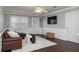 Cozy living room featuring a leather sofa, modern ceiling fan, and hardwood floors at 4344 White Surrey Nw Dr, Kennesaw, GA 30144