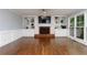 Cozy living room features hardwood flooring, a brick fireplace, and built-in shelving with large windows at 4344 White Surrey Nw Dr, Kennesaw, GA 30144