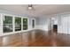 Sun-filled living area with hardwood floors, large windows, a glass door, and access to the kitchen at 4344 White Surrey Nw Dr, Kennesaw, GA 30144