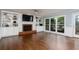 Inviting living room featuring hardwood floors, a fireplace flanked by built-ins, and natural light at 4344 White Surrey Nw Dr, Kennesaw, GA 30144