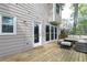 Wooden patio area with a wicker outdoor seating set that looks to the side of the home at 4344 White Surrey Nw Dr, Kennesaw, GA 30144