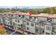 Aerial view of townhome rooftops with patios, decks, and a red pin indicating location at 1199 Huff Nw Rd # 112, Atlanta, GA 30318