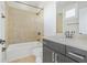 Tiled bathroom with tub and shower combination, dark vanity, and neutral countertop at 1199 Huff Nw Rd # 112, Atlanta, GA 30318