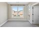 Bright bedroom featuring a large window with neighborhood views and neutral carpeting at 1199 Huff Nw Rd # 112, Atlanta, GA 30318