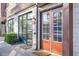 Charming front entrance with orange door, glass panes and stone accents, offering a warm welcome at 1199 Huff Nw Rd # 112, Atlanta, GA 30318