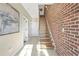 Hallway with a brick accent wall and wood stairs, leading to the upper level at 1199 Huff Nw Rd # 112, Atlanta, GA 30318