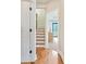 Hallway with hardwood floors and white painted door to interior rooms, with natural light at 1199 Huff Nw Rd # 112, Atlanta, GA 30318