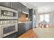 Well-appointed kitchen with granite countertops, stainless steel appliances and brick design at 1199 Huff Nw Rd # 112, Atlanta, GA 30318