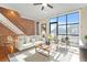 Sunlit living room showcases hardwood floors, a cozy sofa, and large windows for city views at 1199 Huff Nw Rd # 112, Atlanta, GA 30318