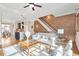 Bright living room boasts modern decor, hardwood floors, brick accent wall and open floor plan at 1199 Huff Nw Rd # 112, Atlanta, GA 30318