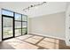 Open living room featuring large windows for natural light and wood floors at 1199 Huff Nw Rd # 112, Atlanta, GA 30318