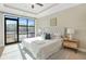 Bright main bedroom with carpet floors, tray ceilings and a sliding glass door to exterior balcony at 1199 Huff Nw Rd # 112, Atlanta, GA 30318