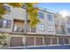 Rear exterior view of modern townhomes with balconies, garages, and ample natural light at 1199 Huff Nw Rd # 112, Atlanta, GA 30318