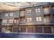 Rear exterior view of modern townhomes with balconies, garages, and ample natural light at 1199 Huff Nw Rd # 112, Atlanta, GA 30318