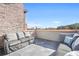 Relaxing rooftop deck featuring comfortable couches with views of the cityscape in the distance at 1199 Huff Nw Rd # 112, Atlanta, GA 30318