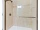 This bathroom features a large walk-in shower with glass doors and tan ceramic tiles at 1199 Huff Nw Rd # 112, Atlanta, GA 30318