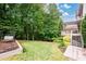 Lush backyard with a well-maintained lawn, wooden deck, and mature trees, perfect for outdoor activities at 1430 Hampton Hill Dr, Alpharetta, GA 30022