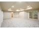 Finished basement with drop ceiling lights, carpet and a fridge at 1430 Hampton Hill Dr, Alpharetta, GA 30022