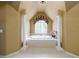 Luxurious bathroom featuring a large soaking tub surrounded by columns and elegant decor at 1430 Hampton Hill Dr, Alpharetta, GA 30022