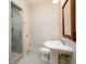 Small bathroom features a standing shower with glass doors and a pedestal sink at 1430 Hampton Hill Dr, Alpharetta, GA 30022