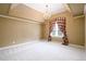 Spacious bedroom featuring plush carpeting, a decorative chandelier, and a window with elegant curtains at 1430 Hampton Hill Dr, Alpharetta, GA 30022