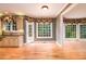 Sun-filled dining area featuring wood floors, large windows, and seamless kitchen access at 1430 Hampton Hill Dr, Alpharetta, GA 30022