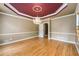 Formal dining room with hardwood floors, elegant chandelier, and beautiful ceiling detail at 1430 Hampton Hill Dr, Alpharetta, GA 30022