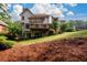 The house has a spacious backyard with a wooden deck and mature trees, perfect for outdoor activities at 1430 Hampton Hill Dr, Alpharetta, GA 30022
