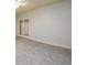 Bright living room with neutral walls and carpet, featuring french doors and natural light at 1430 Hampton Hill Dr, Alpharetta, GA 30022