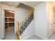 Carpeted staircase with wood banister and open storage area nearby at 1430 Hampton Hill Dr, Alpharetta, GA 30022