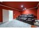 Home theater room with plush seating, projector screen, and rich red walls for an immersive experience at 1430 Hampton Hill Dr, Alpharetta, GA 30022