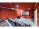Home theater room with plush seating, projector screen, and rich red walls for an immersive experience at 1430 Hampton Hill Dr, Alpharetta, GA 30022