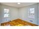 Well-lit bedroom showcasing hardwood floors and two windows bringing in natural light at 1760 Detroit Nw Ave, Atlanta, GA 30314
